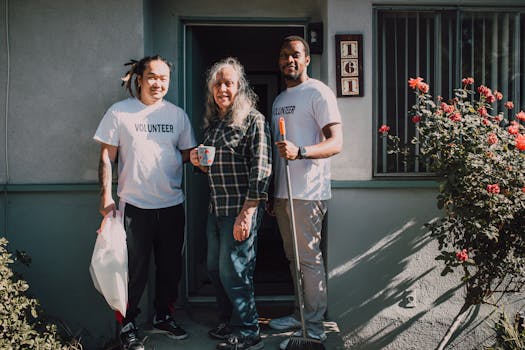 Two volunteers assist a community member outside their home, fostering social good.